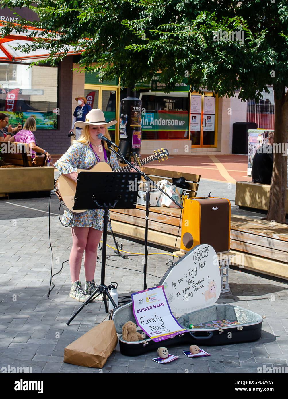 13 year old Emily, singer and guitarist, buskiking at Tamworth Country Musuc Festival. Stock Photo