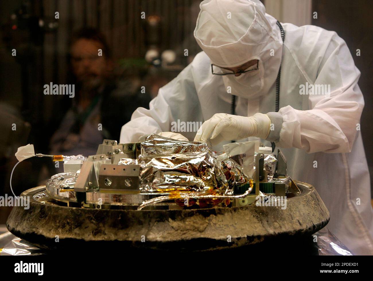 Ron Ceeders, a Lockheed Martin technician, unbolts a canister ...