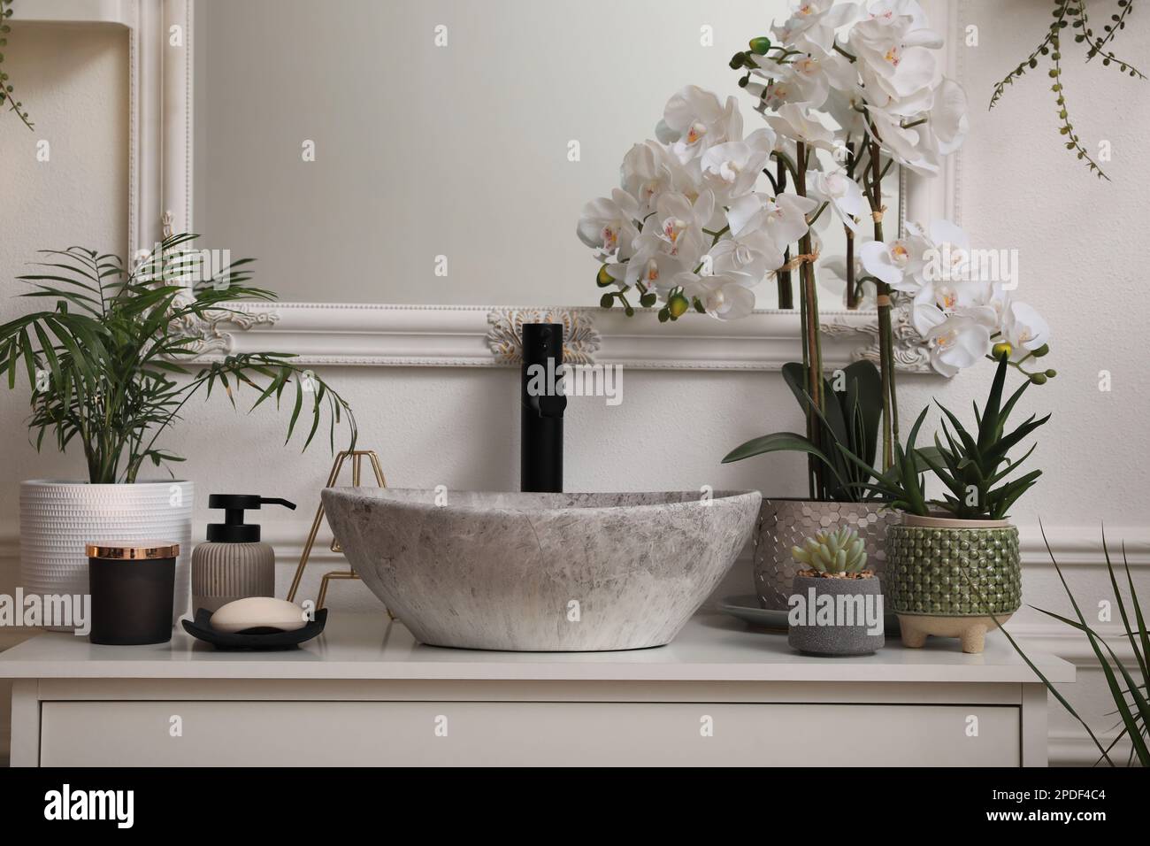 Stylish sink and beautiful houseplants in bathroom. Interior design Stock Photo