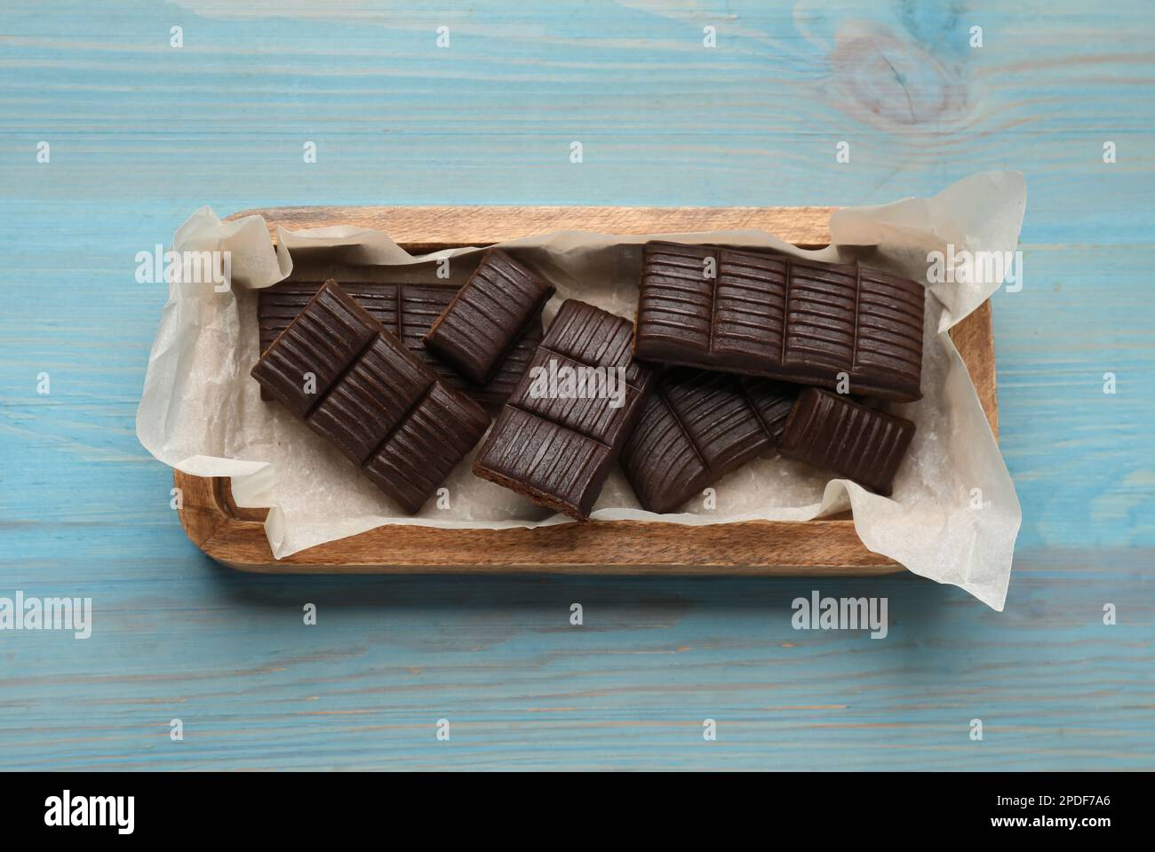 Tray with delicious hematogen on blue wooden table, top view Stock Photo