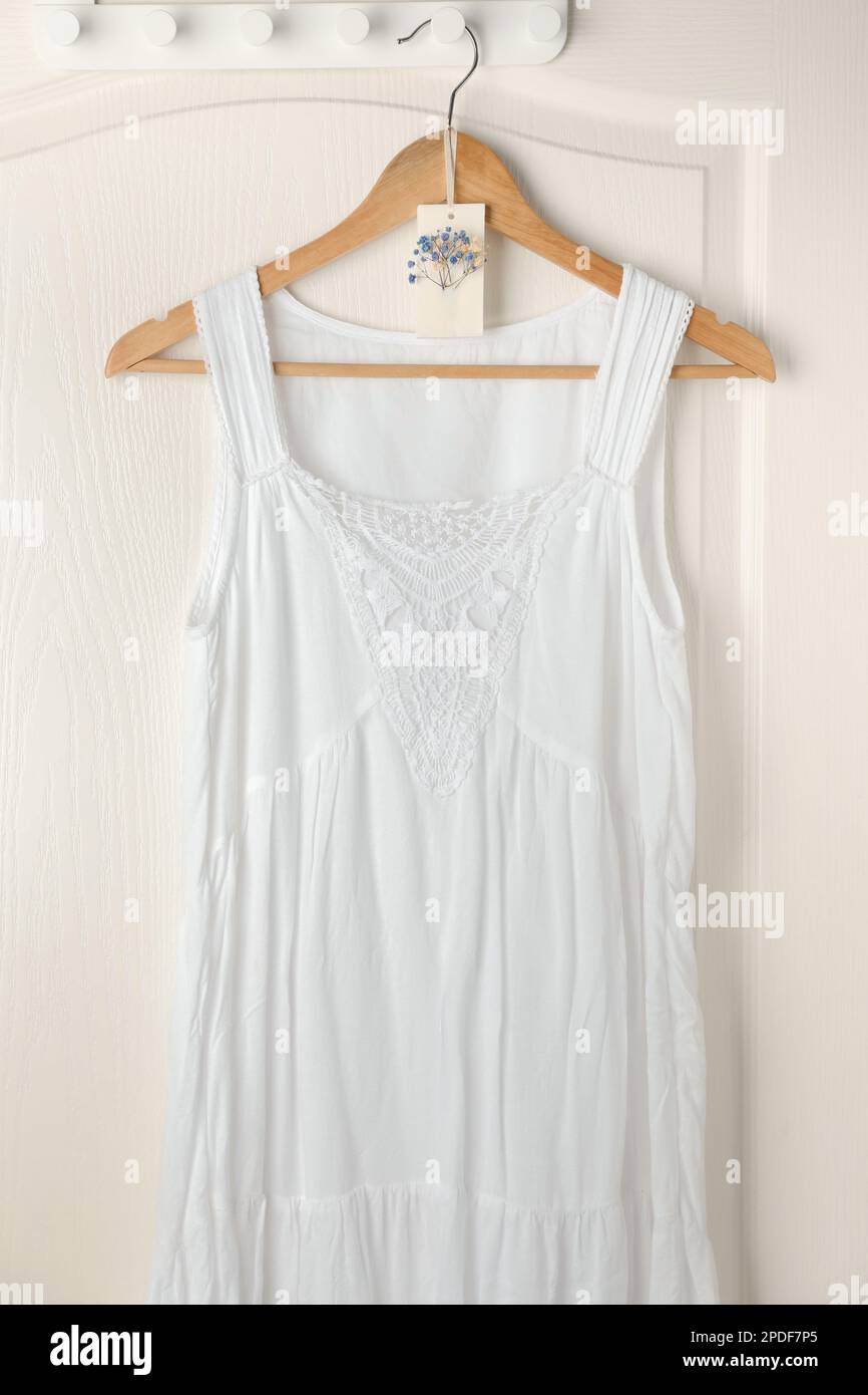 Scented sachet with flowers and stylish clothes on hanger Stock Photo