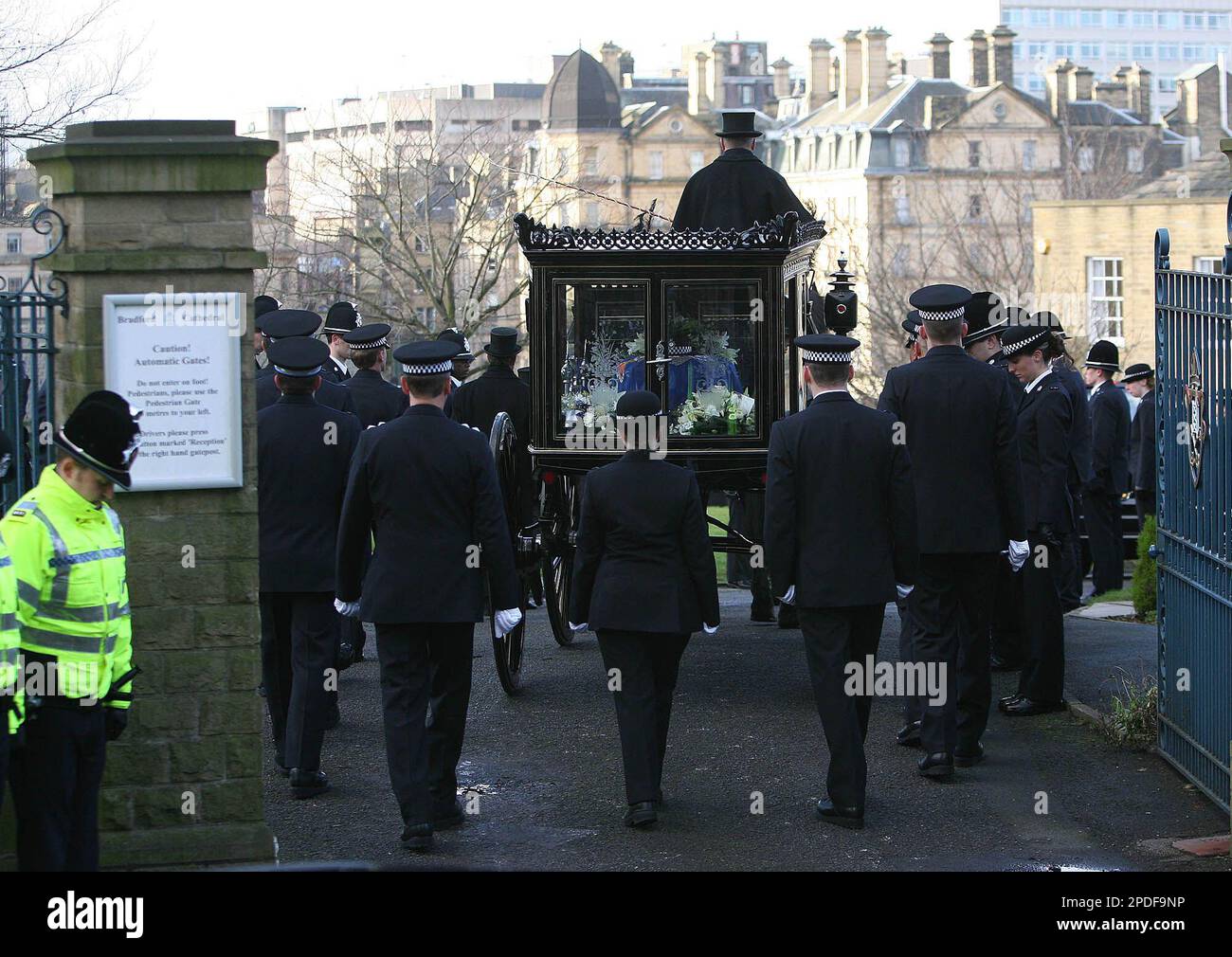 Teresa Milburn, centre, colleague of murdered West Yorkshire police officer Sharon Beshenivsky, follows the horse drawn carriage into the grounds of Bradford Cathedral at the funeral which took place in Bradford, England, Wednesday Jan. 11, 2006. Beshenivsky was gunned down on Nov. 18, 2005 while investigating a robbery. (AP Photo/Dave Thompson) Stock Photo