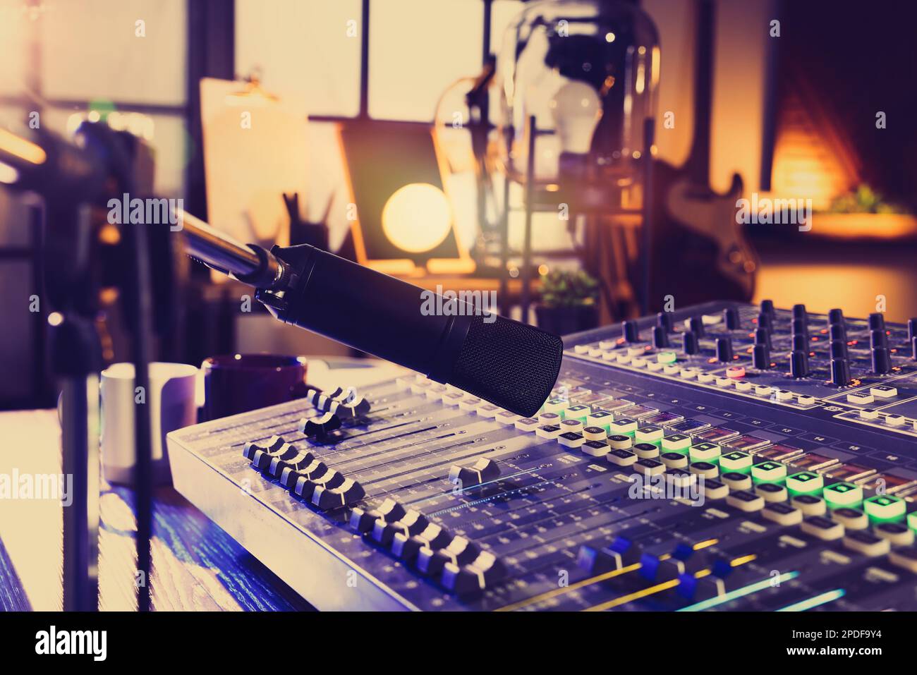 Microphone over professional mixing console on table in radio studio ...