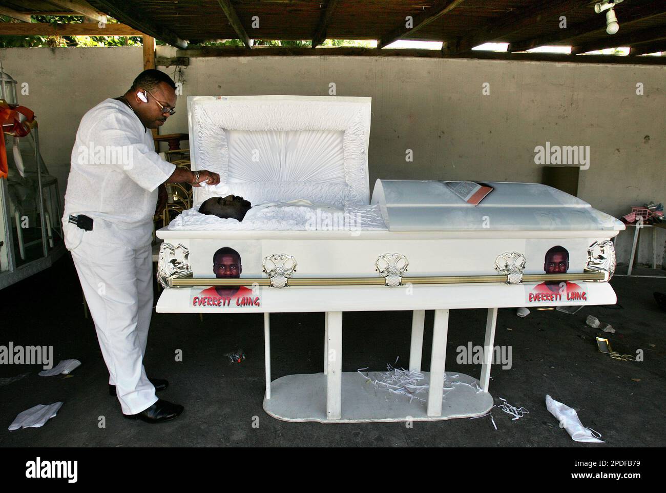 Before the start of an opencasket church burial service, Jamaican mortician Tommy Thomson