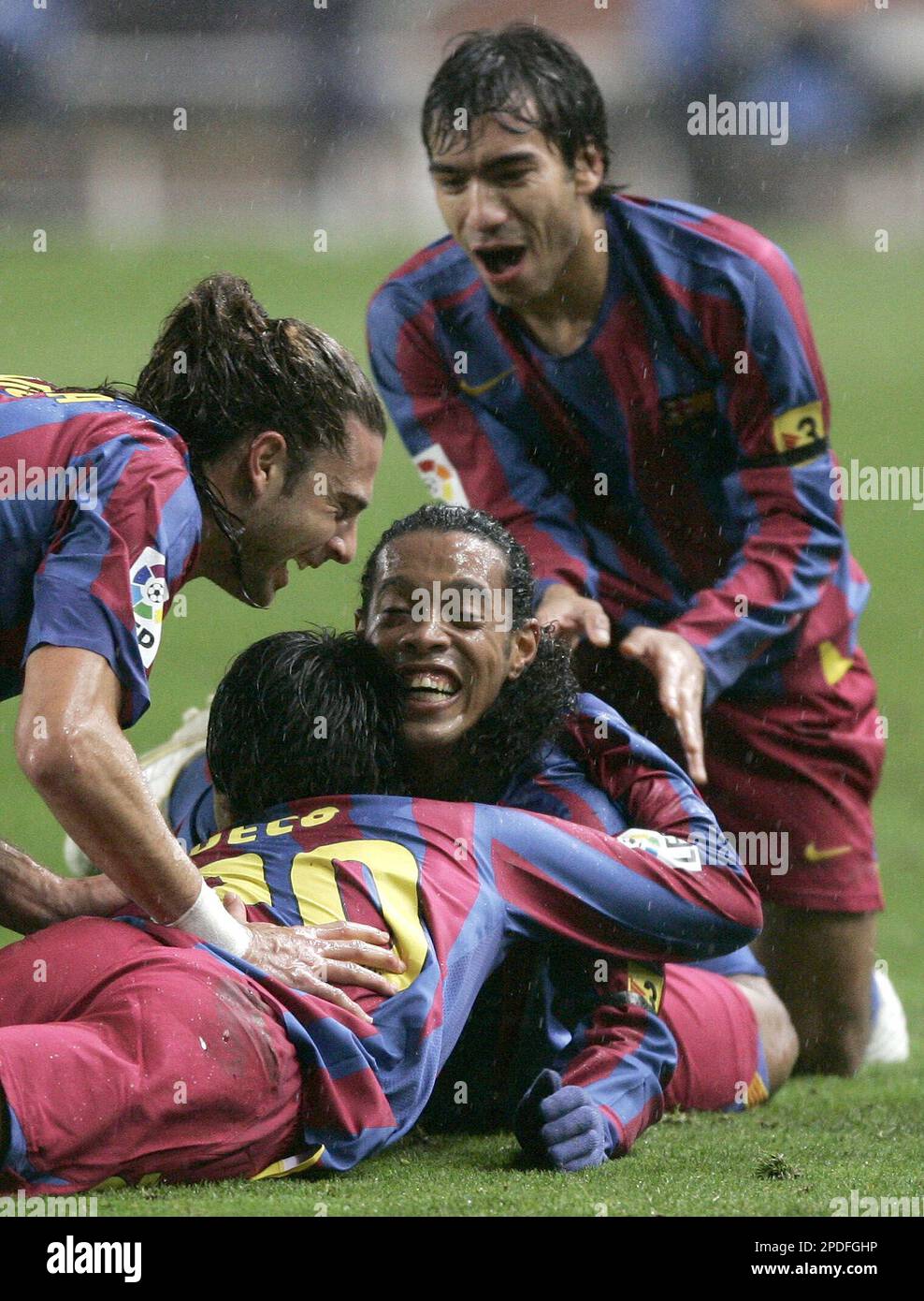 FC Barcelona player Deco, from Portugal, down, is congratulated by