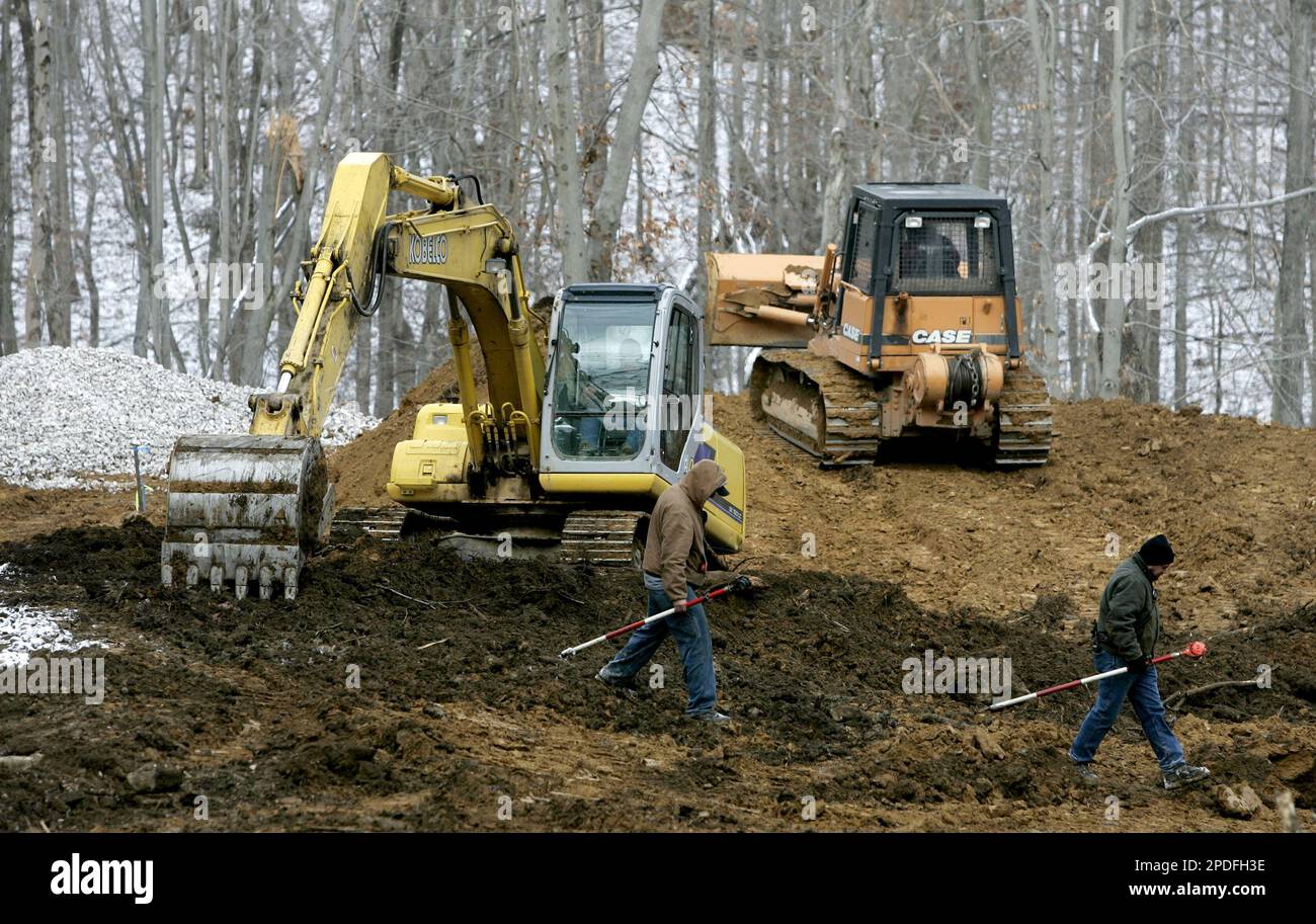 Contractors with the International Coal Group carry surveying equipment
