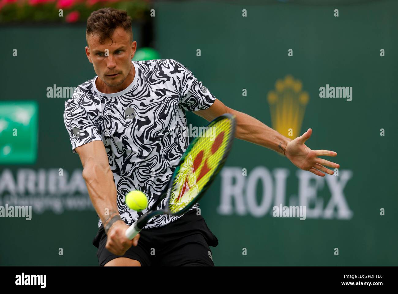 March 14, 2023 Marton Fucsovics of Hungary returns a shot against Taylor Fritz during the 2023 BNP Paribas Open at Indian Wells Tennis Garden in Indian Wells, California
