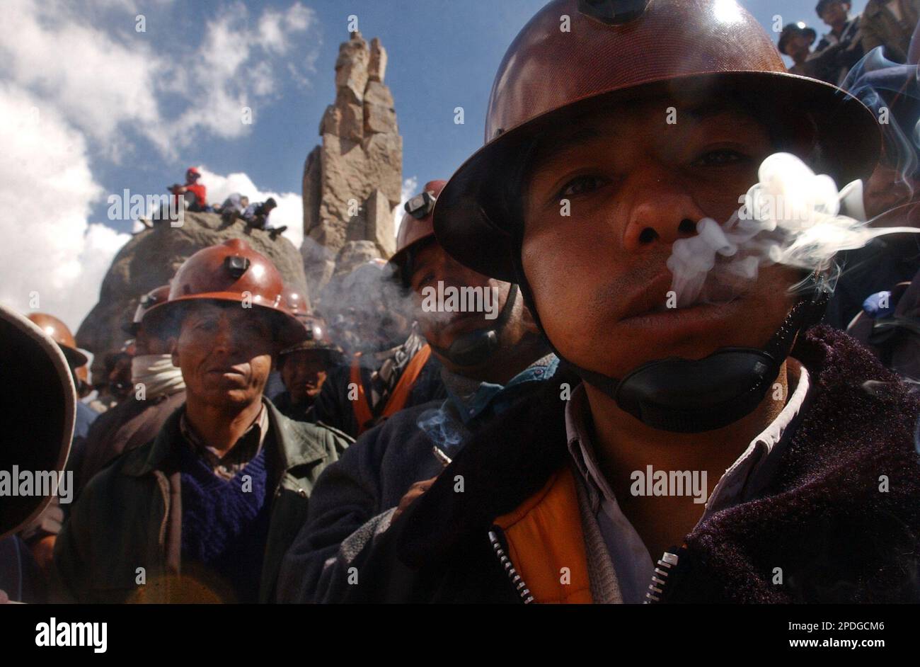 With his mouth full of coca leaves that they chew as they smoke 