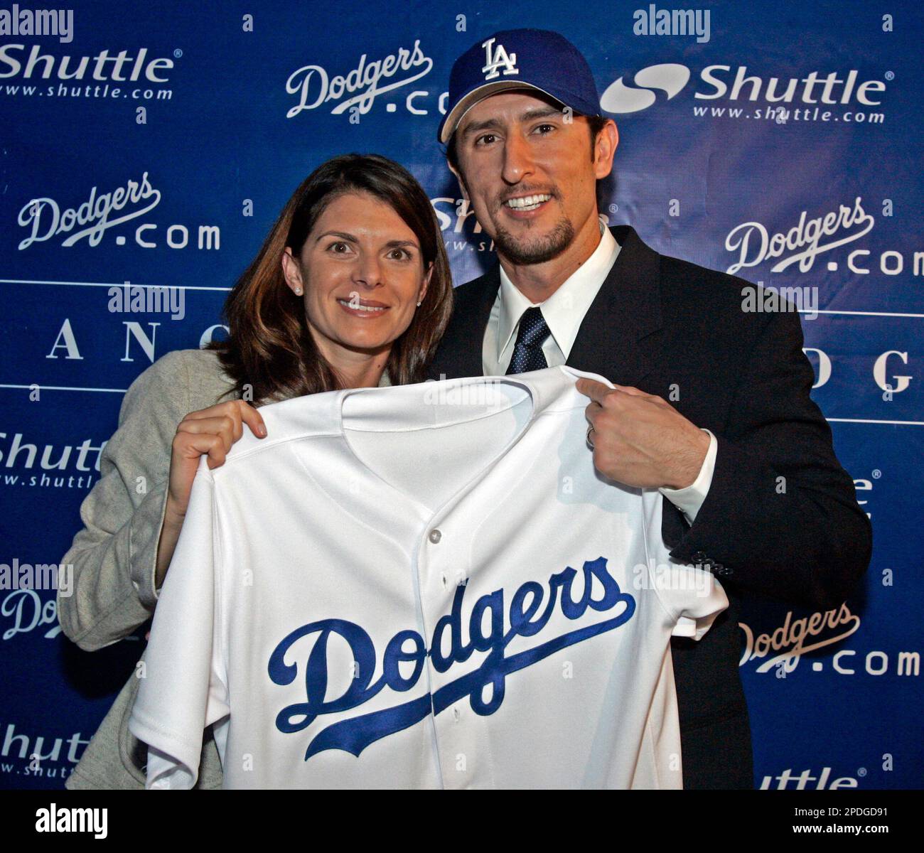 Five-time All-Star Nomar Garciaparra, right, holds his new Los