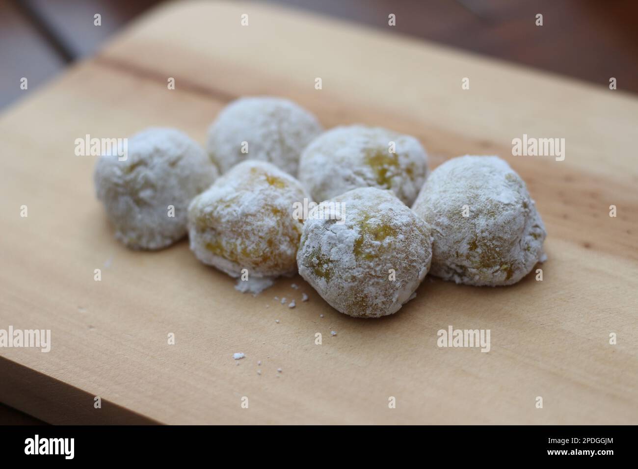 a close up of durian-flavored mochi served on a cutting board and ready to be eaten. Stock Photo