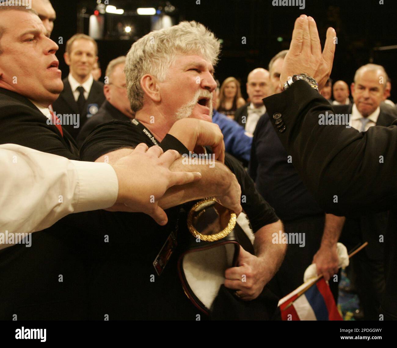 Norman Stone, center, coach of U.S. boxer John Ruiz , unseen, tries to grab  the winner's belt after boxer Nikolay Valuev from Russia, unseen, won the  WBA Heavyweight title in Berlin early