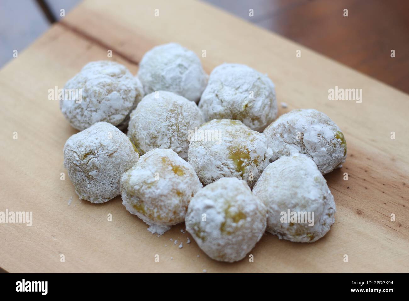 a close up of durian-flavored mochi served on a cutting board and ready to be eaten. Stock Photo