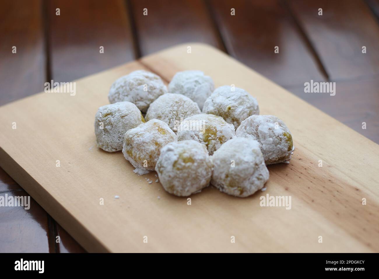 a close up of durian-flavored mochi served on a cutting board and ready to be eaten. Stock Photo