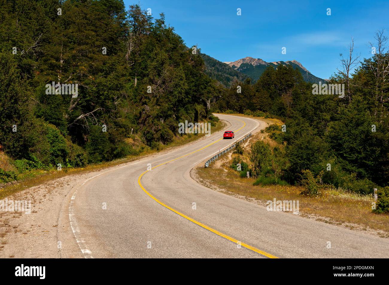 Tourists driving on the beautiful scenery of snowy mountains on Ruta 40, Ruta de Los Siete Lagos or Route of Seven Lakes, Neuquén, Argentina Stock Photo
