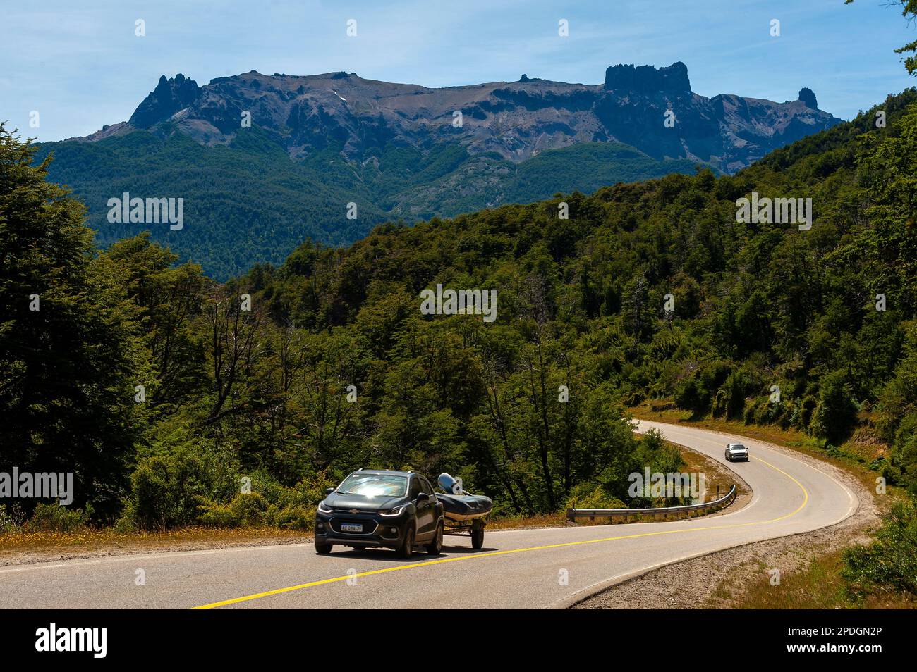 Tourists driving on the beautiful scenery of snowy mountains on Ruta 40, Ruta de Los Siete Lagos or Route of Seven Lakes, Neuquén, Argentina Stock Photo