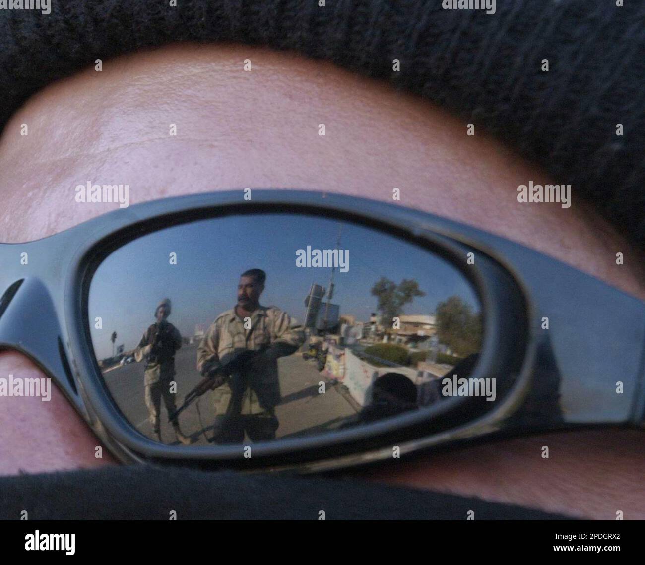 Iraqi soldiers are reflected in the sunglasses of fellow soldier at a  checkpoint in Baqouba, Iraq, Wednesday, Dec. 14, 2005. Campaigning came to  a stop Wednesday around Iraq to give the country's