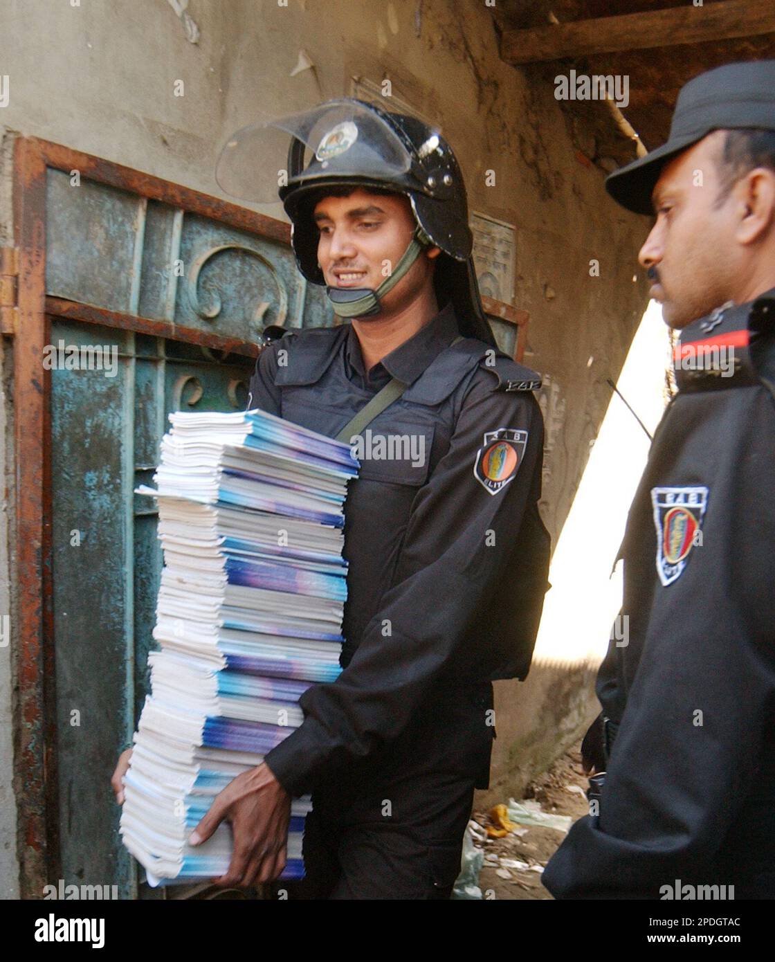 A Bangladesh Special Security Force soldier carries books of Jihad, or
