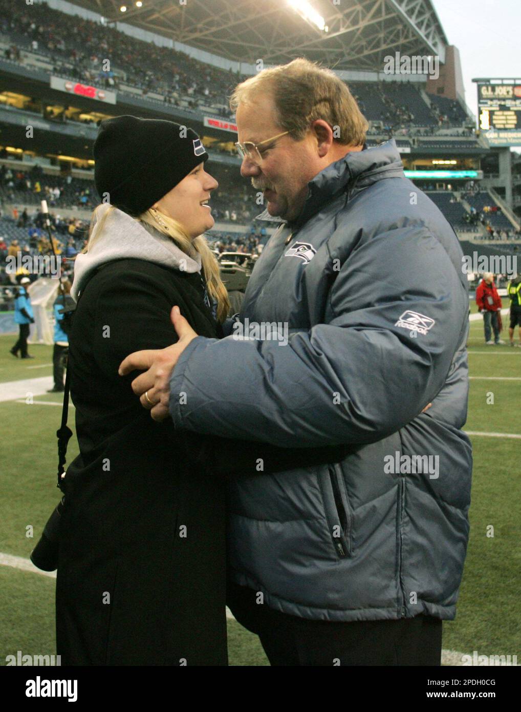 Seattle Seahawks head coach Mike Holmgren is greeted by his daughter