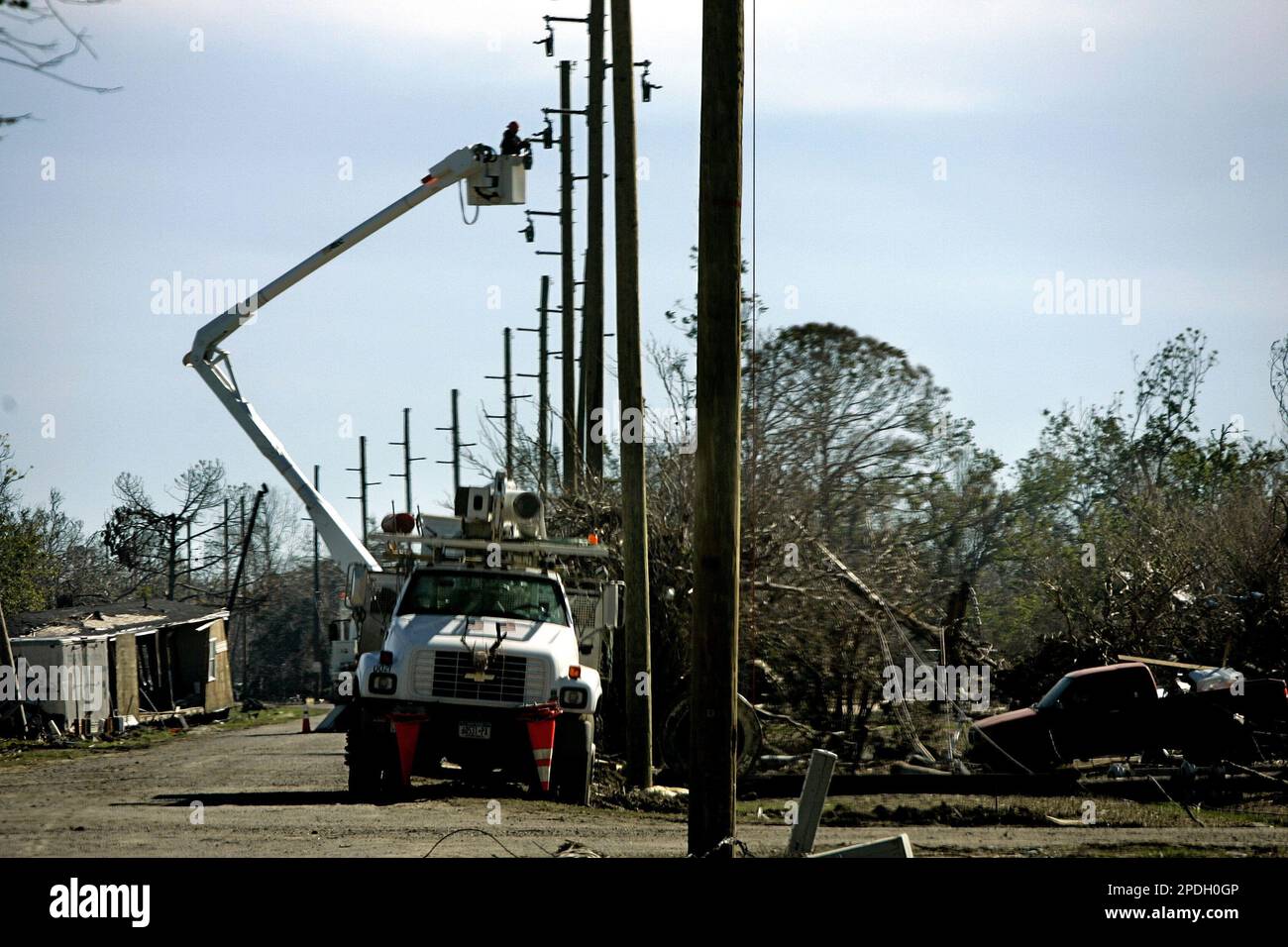 Workers work on electric lines in Buras, La., Sunday, Dec. 11, 2005