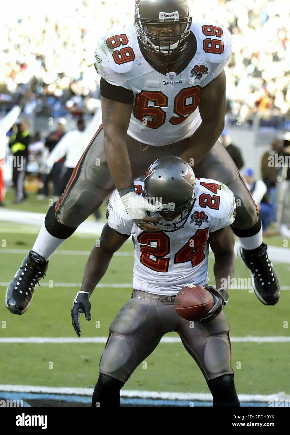Tampa Bay Buccaneers' Anthony Davis (69) leap-frogs over