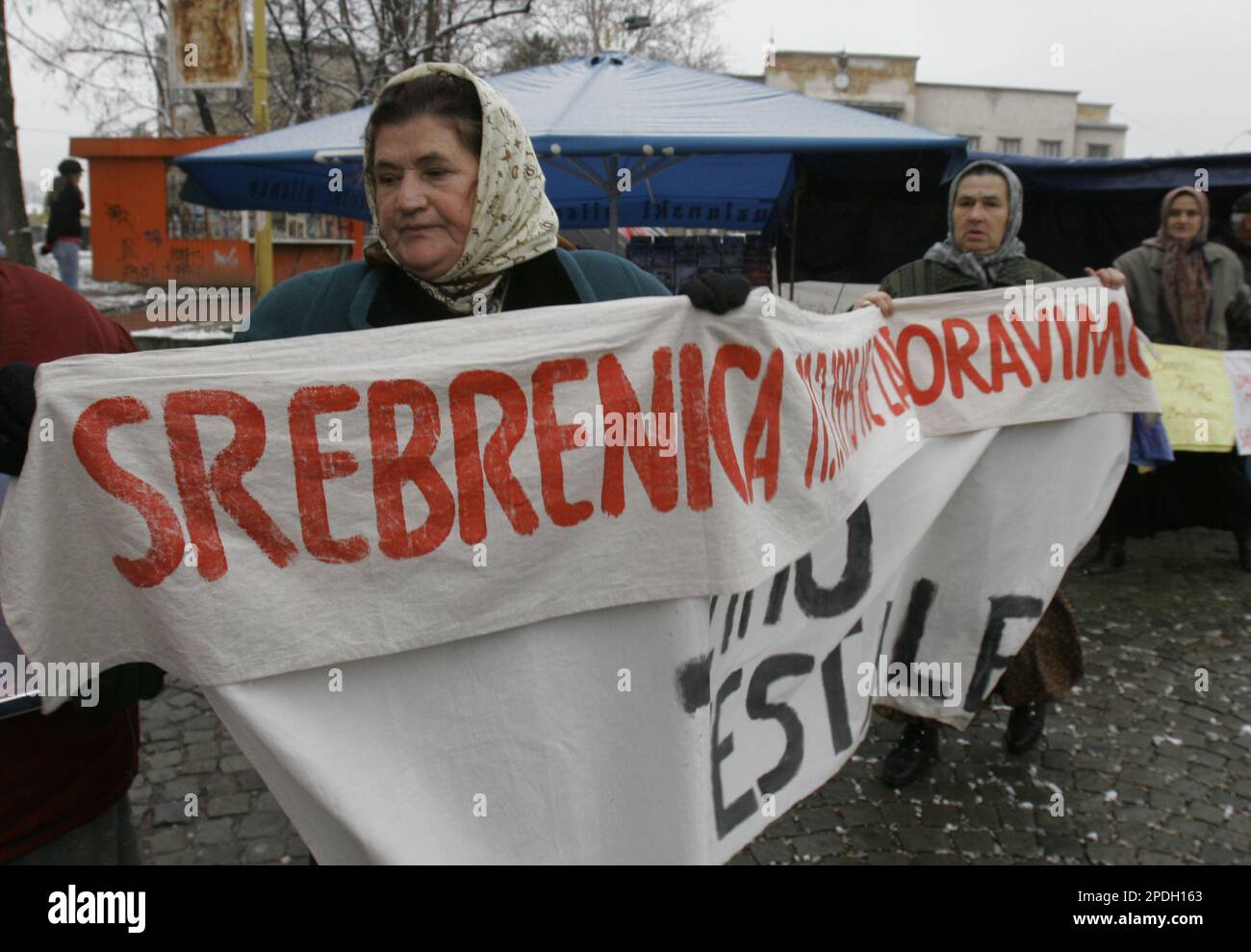 Women of Srebrenica holding baner with name of missing from Srebrenica  writen on it during protest of the Srebrenica families ,in northern Bosnian  town of Tuzla 75 kms noth of Sarjevo, on