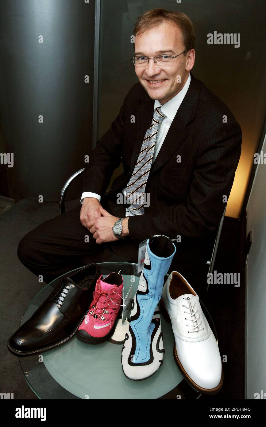 Chief Operating Officer for ECCO Mikael Thinghuus, poses with some ECCO  shoes in Brussels, Thursday Dec. 8, 2005. Danish shoemaker ECCO came to  Brussels to protest at possible EU tariffs aimed at