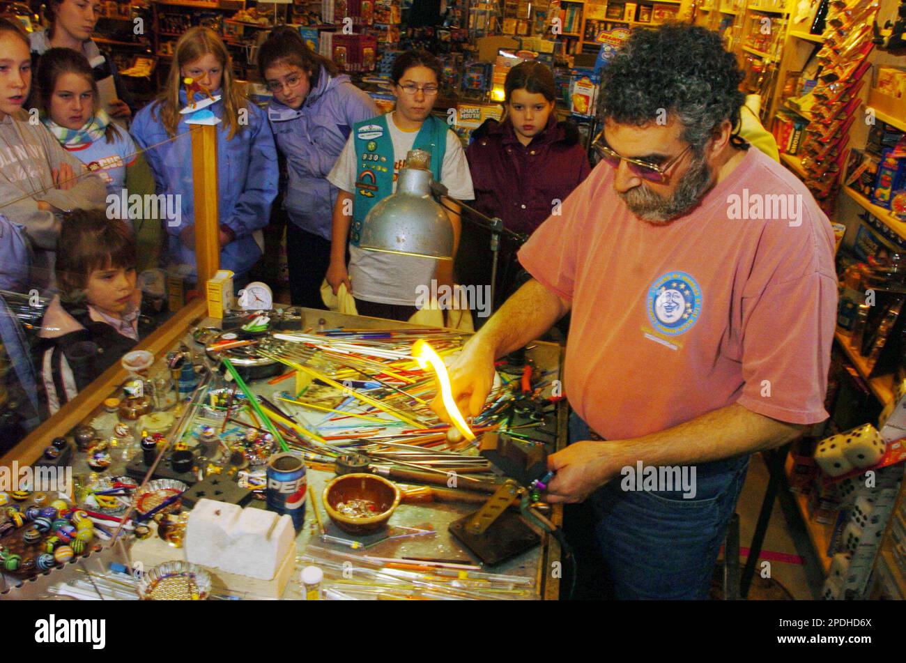 Artist Bruce Breslow, owner of Moon Marble Co., Bonner Springs, Kan. gives  a demonstration to a Girls Scout troop, Nov. 17, 2005, on creating marbles.  (AP Photo-Lawrence Journal-World,Richard Gwin Stock Photo -