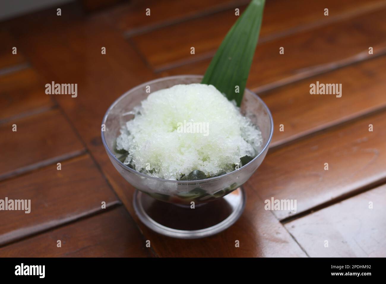 Es Kacang Merah or a cold drink made from red beans boiled with brown sugar served with coconut milk, shaved ice and covered with sweetened condensed Stock Photo