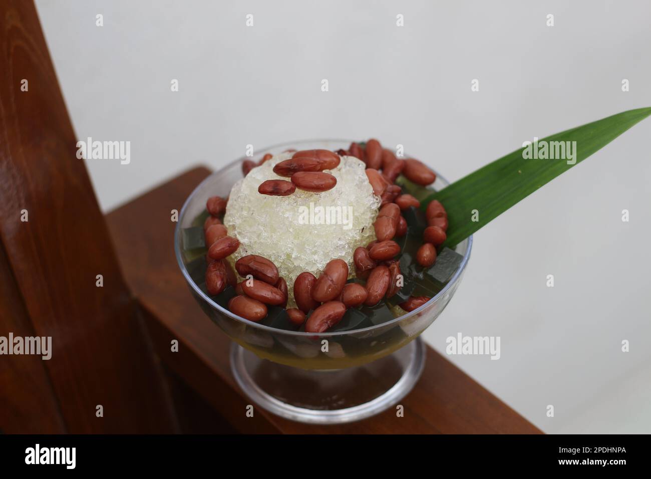 Es Kacang Merah or a cold drink made from red beans boiled with brown sugar served with coconut milk, shaved ice and covered with sweetened condensed Stock Photo