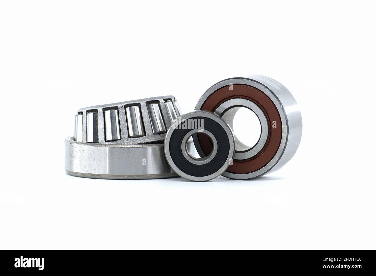 Various ball bearings and tapered roller bearing isolated on white background. Spare parts for