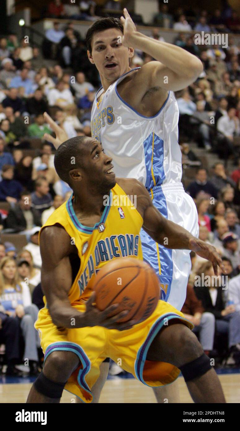 New Orleans Hornets guard Speedy Claxton (5) shoots while defended by San  Antonio Spurs guard Michael Finley (4) during the second half of an NBA  basketball game Sunday, Dec. 18, 2005, in