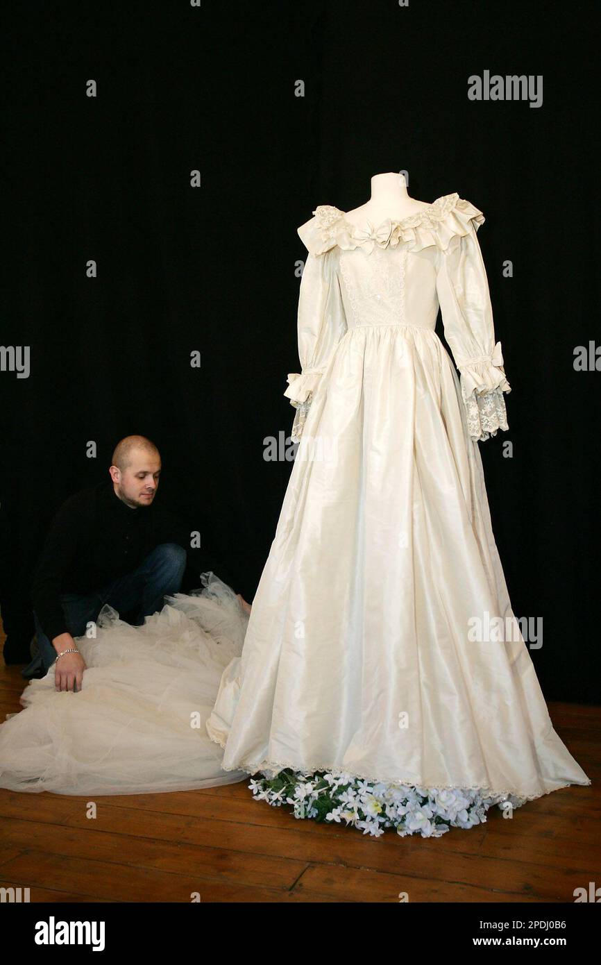 Ben Cleminson, a member of staff of Cooper Owen auction house, adjusts a  duplicate ivory silk taffeta dress at the Proud Galleries in London  Tuesday, Nov. 29 2005, which Lady Diana Spencer