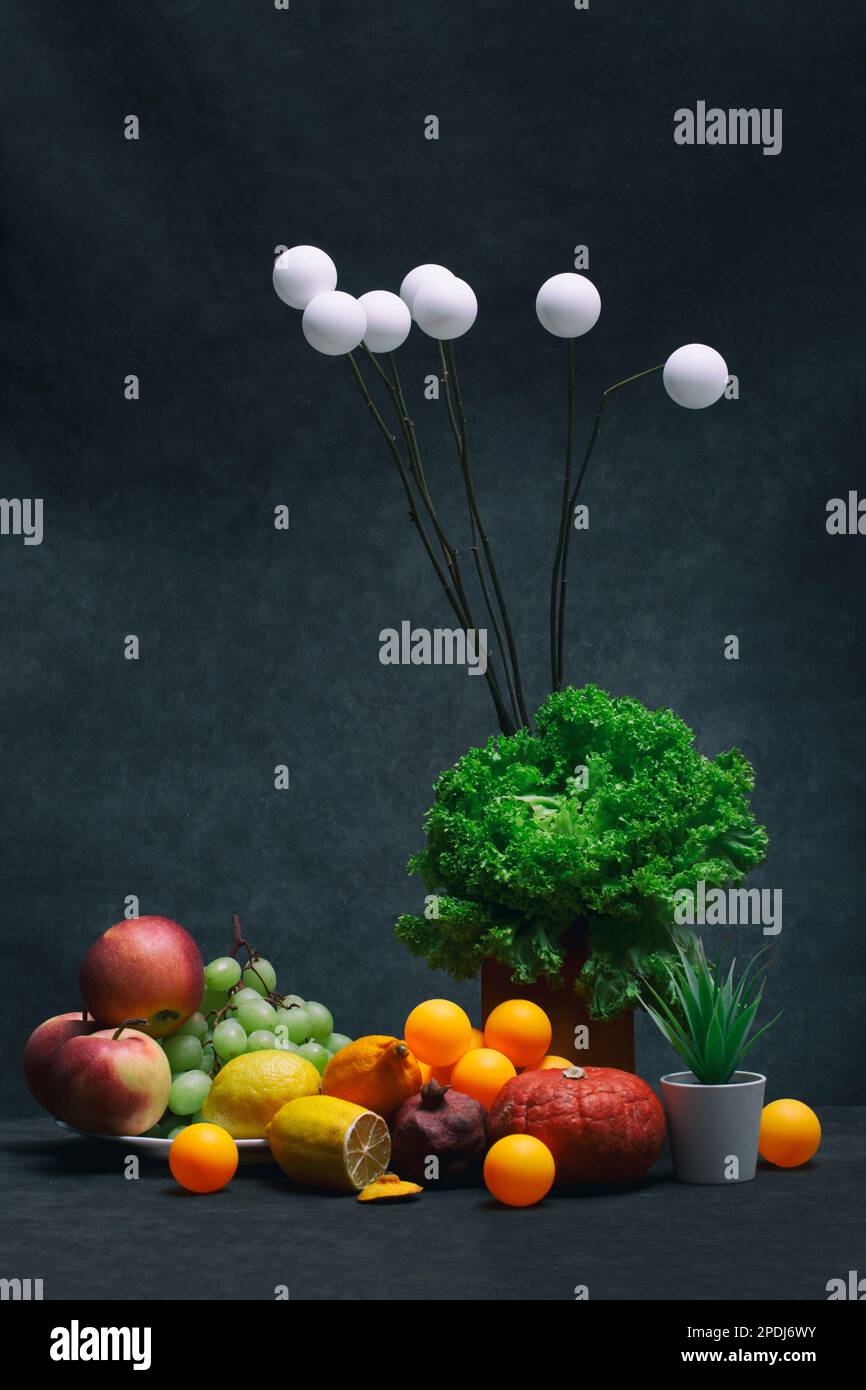 Still life with fruits and vegetables, plants and balls Stock Photo - Alamy