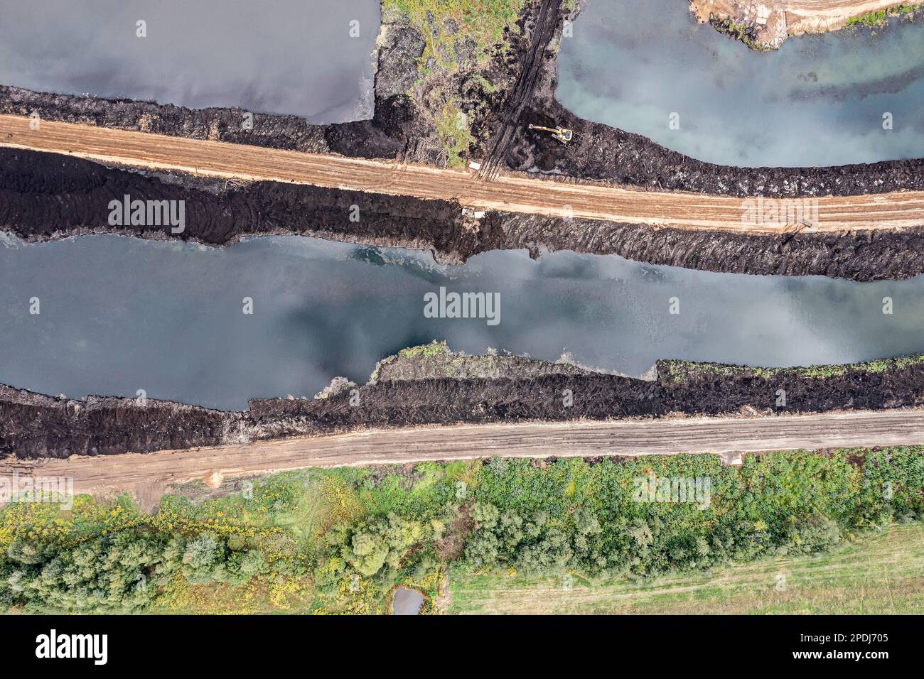 area reclamation and land improvement. excavator working in a swamp. top view from drone. Stock Photo