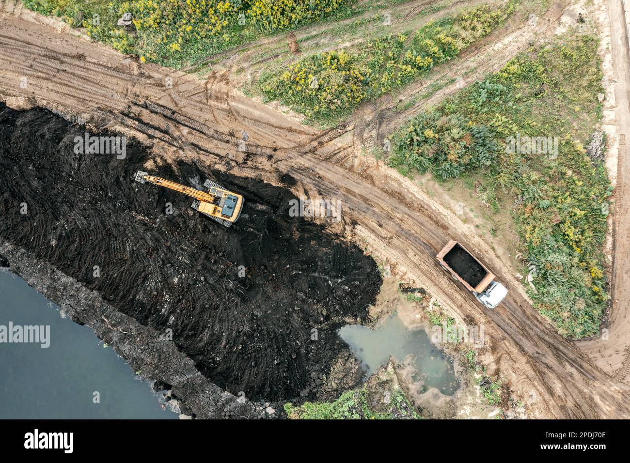 swamp area reclamation using heavy construction machinery. aerial top view. Stock Photo