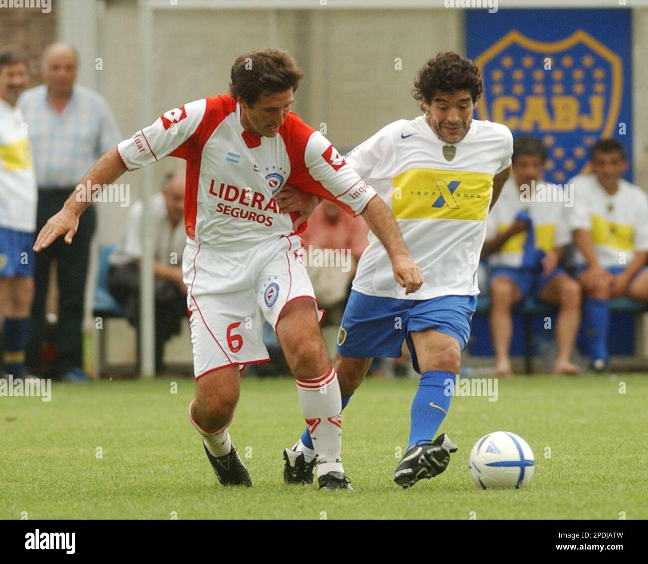 Former Argentina's soccer star Diego Maradona, left, shields the