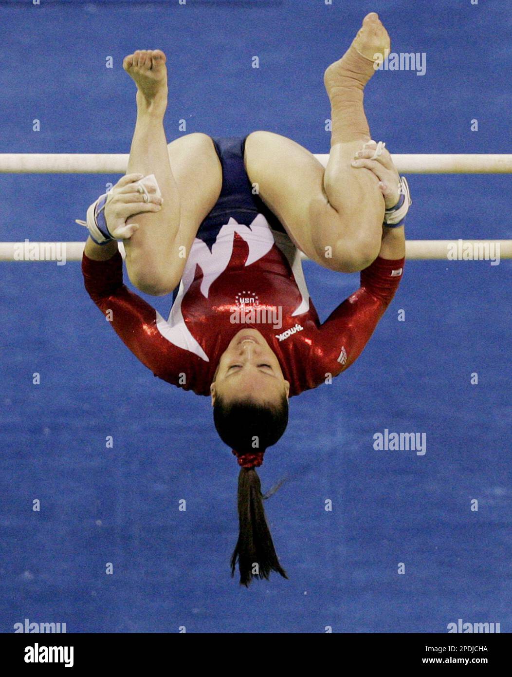 Chellsie Memmel of the U.S. dismounts from the Uneven Bars on day two
