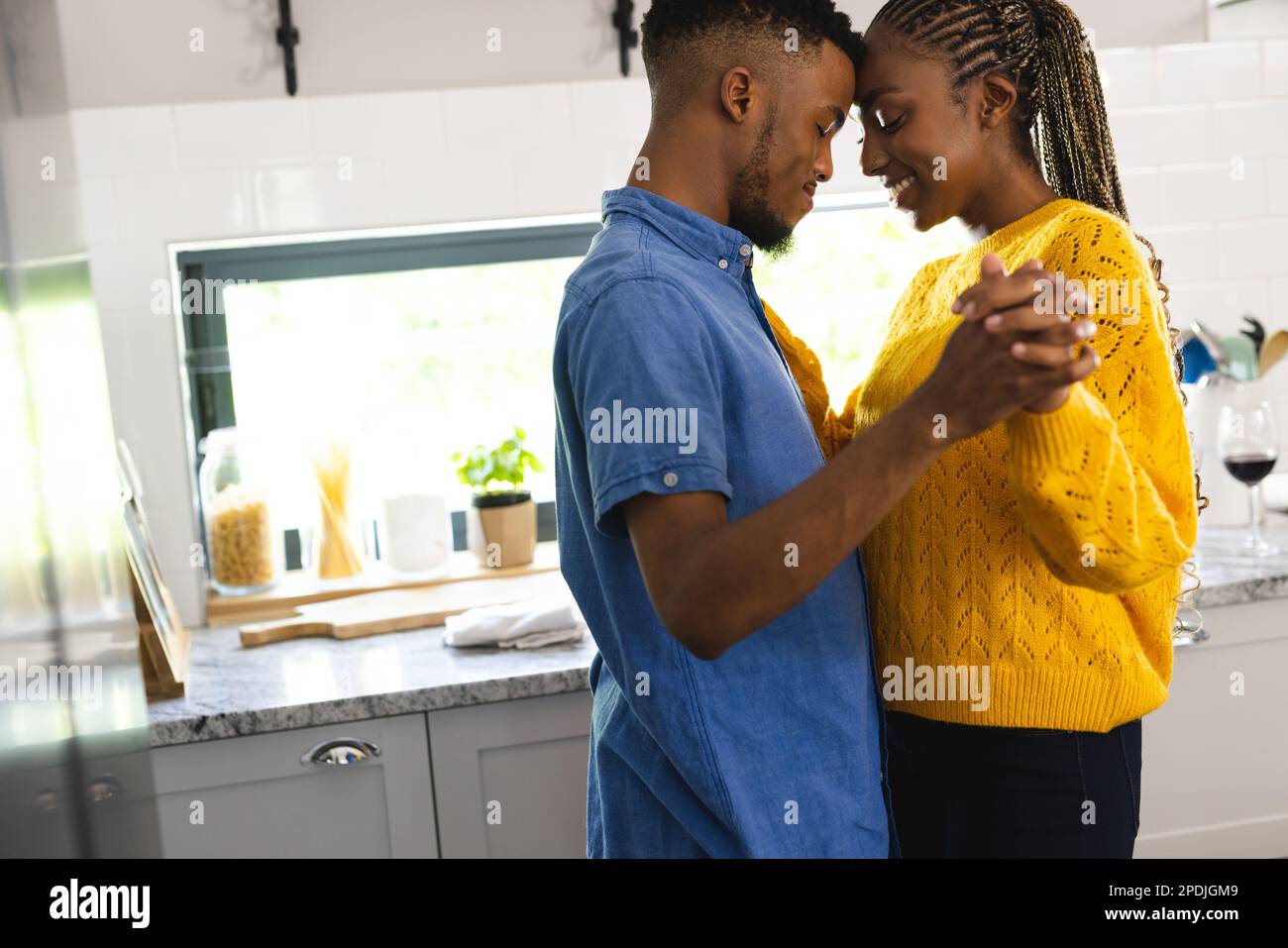 Happy african american couple dancing together in kitchen Stock Photo ...