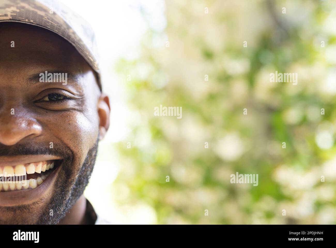 Portrait of happy african american male soldier looking at camera and smiling, with copy space Stock Photo