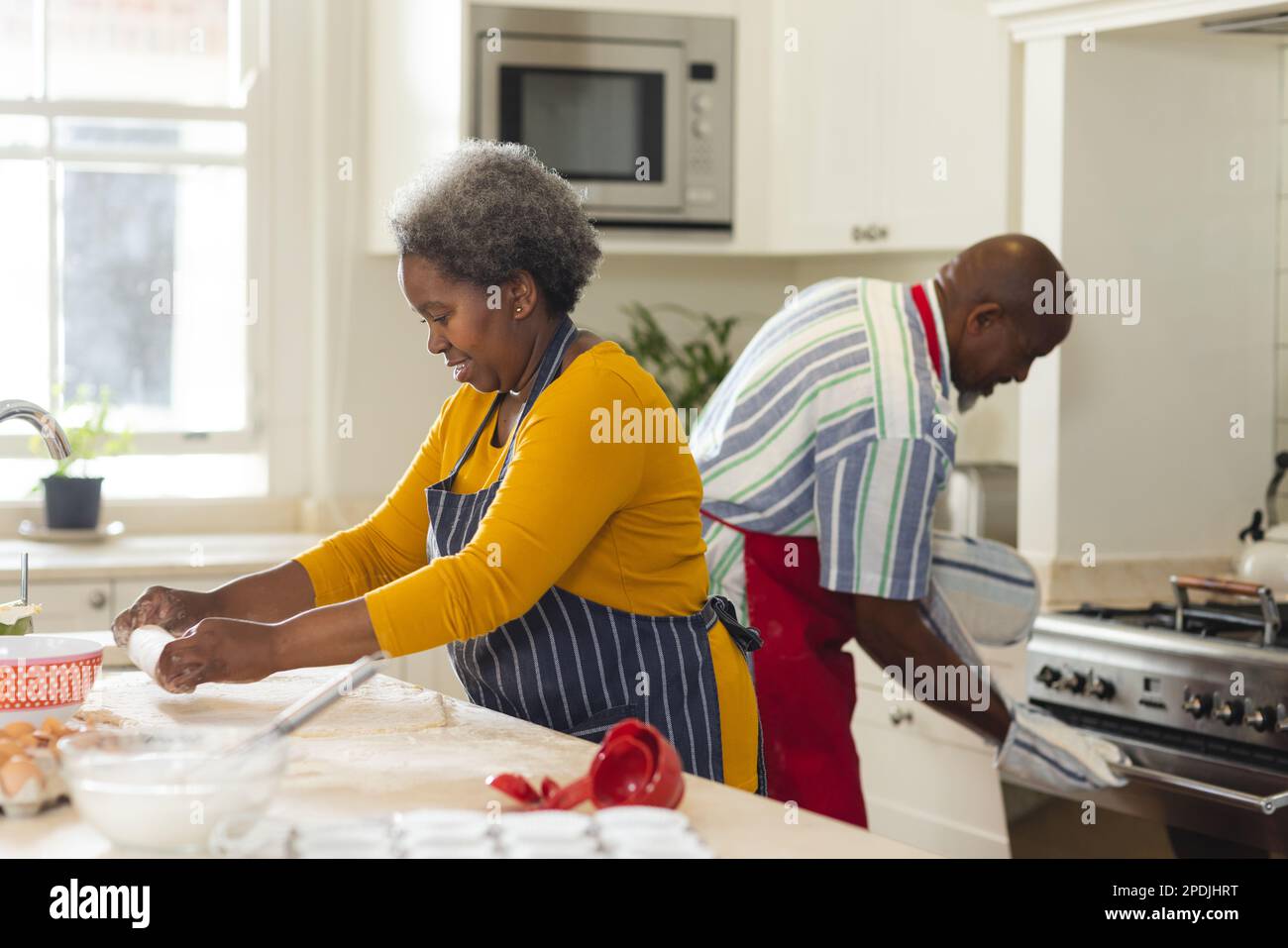 Happy senior african american couple baking together in kitchen Stock ...