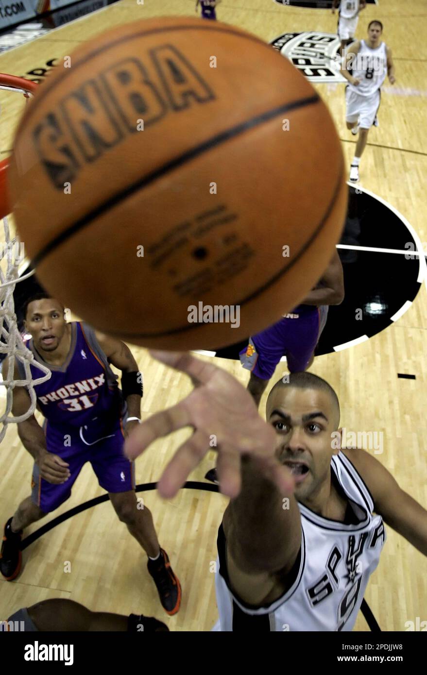 Phoenix Suns guard Steve Nash (13), of Canada, is defended by San Antonio  Spurs' Rasho Nesterovic (8), of Slovenia, and Bruce Bowen as he looks to  pass during the first quarter in