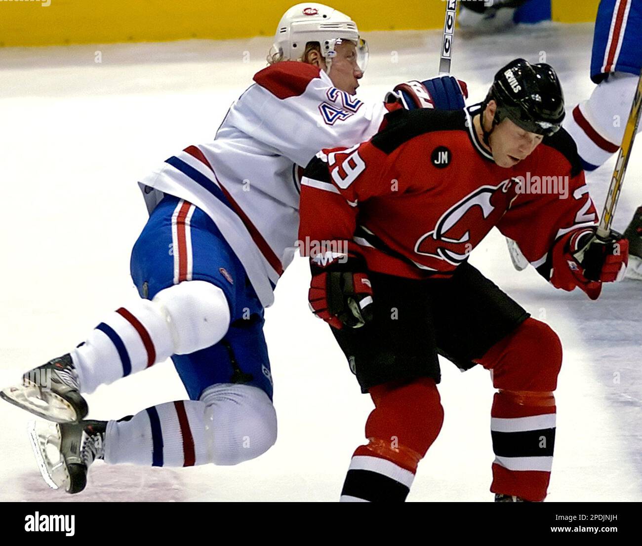 Montreal Canadiens' Alexander Perezhogin, left, of Russia, runs into a ...