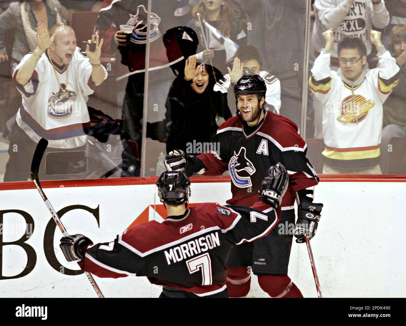 Vancouver Canucks' Todd Bertuzzi, center, is congratulated by team mate  Marek Malik (8) and Markus Naslund (19) after scoring his second goal of  the night against the Anaheim Mighty Ducks during the