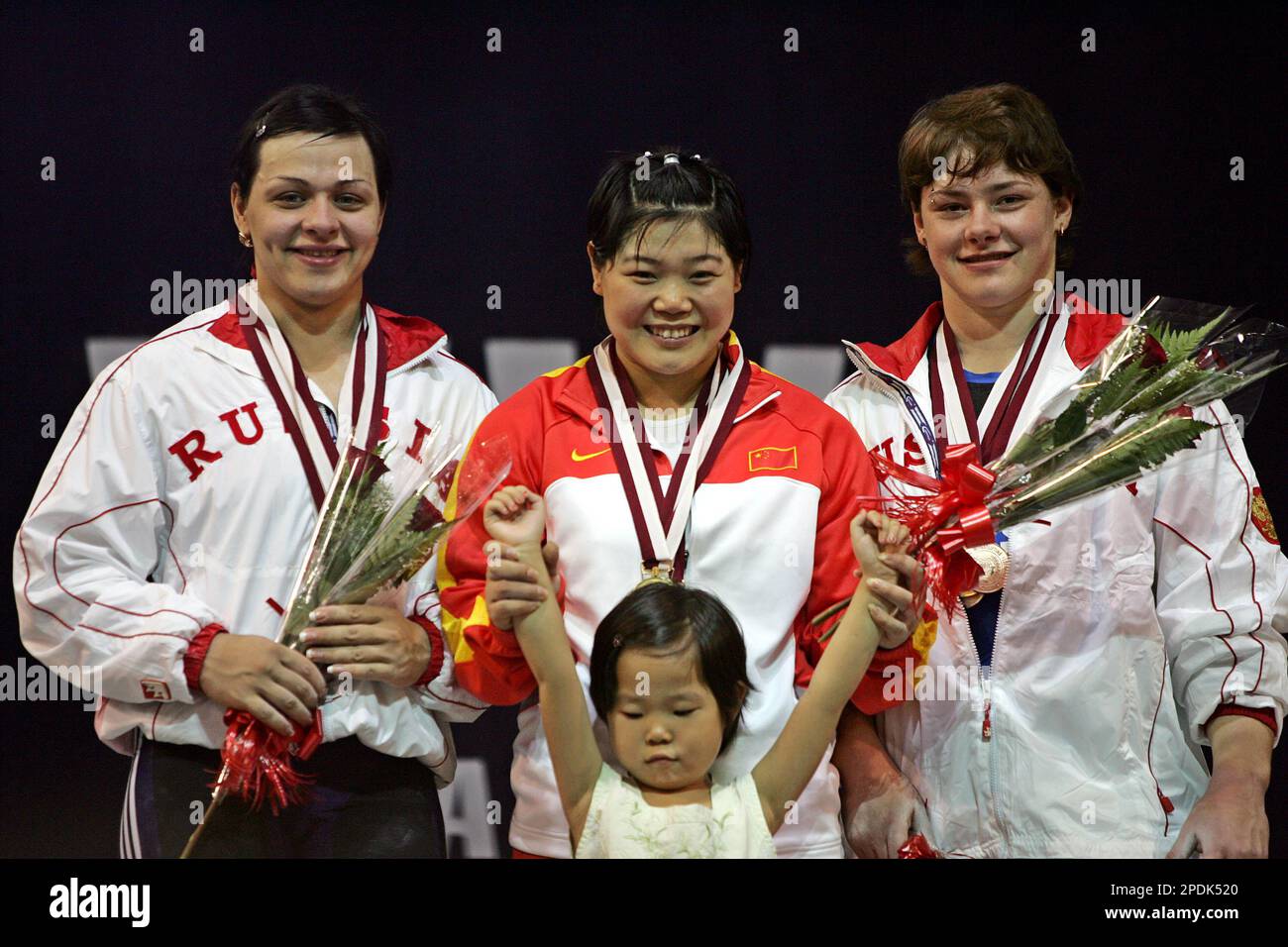 From left to right: Russia's Svetlana Podobedova, silver medalist, China's  Chunhong Liu, gold medalist and Natalia Zabolotnaya, bronze medalist from  Russia celebrate after receive their clean and jerk catagory medals of  women's