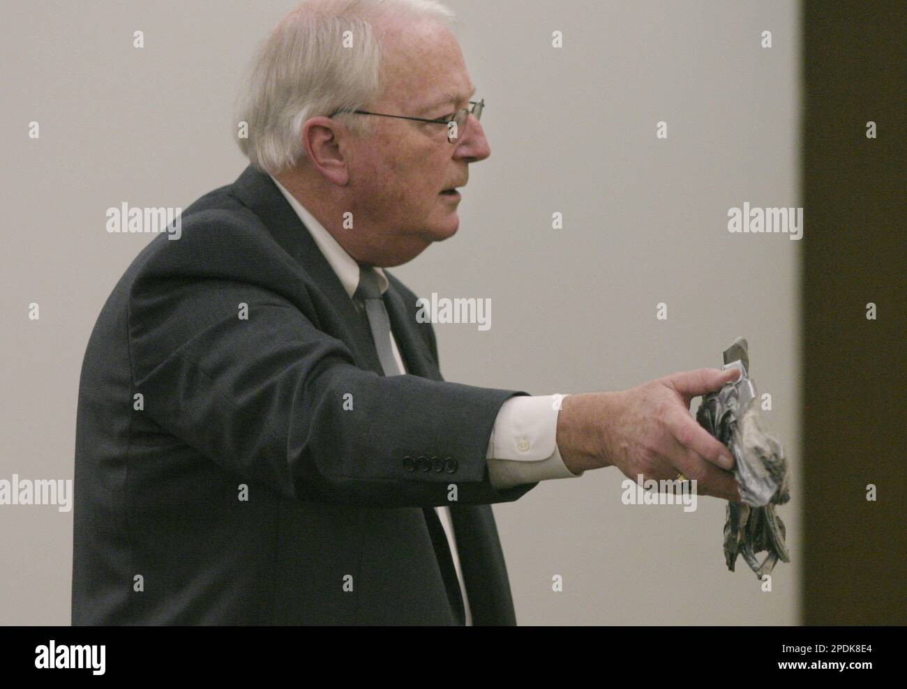 Prosecutor Joe Shannon holds up the duct tape mask that killed Laura