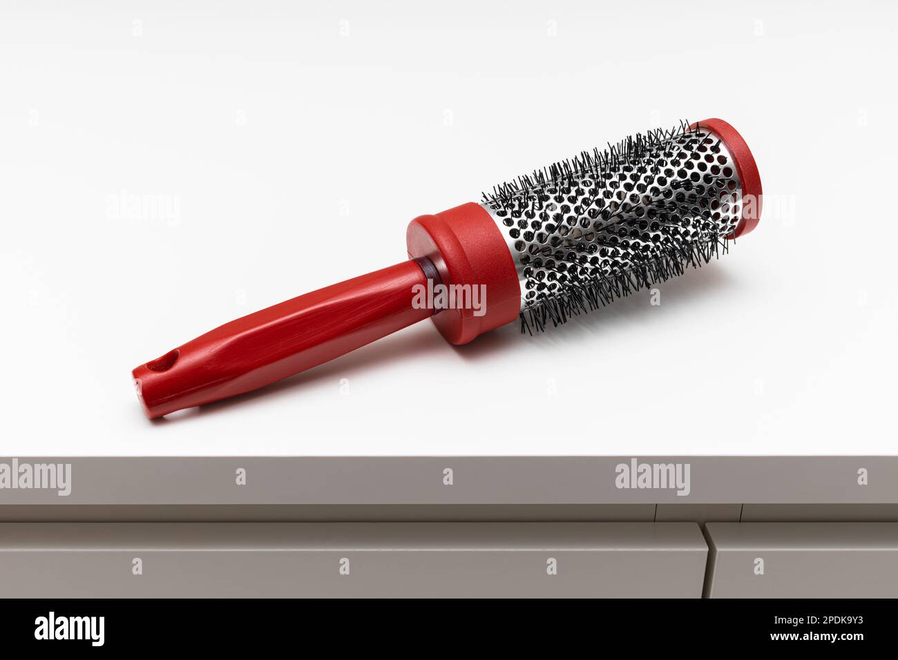round red comb on a white background. old hairbrush on white background ...
