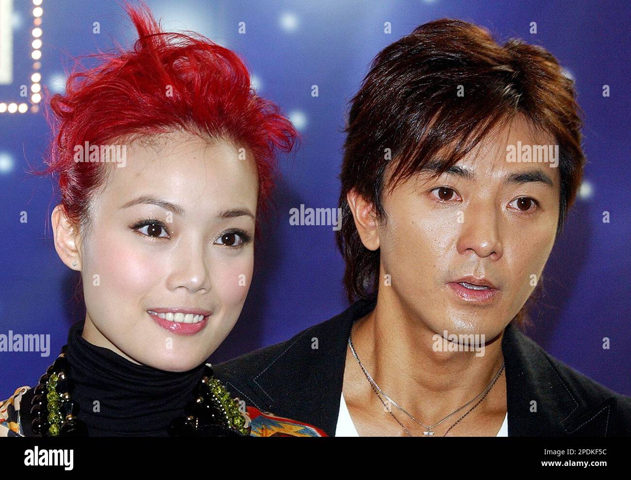Hong Kong singers Ekin Cheng, right, and Joey Yung pose in Hong Kong