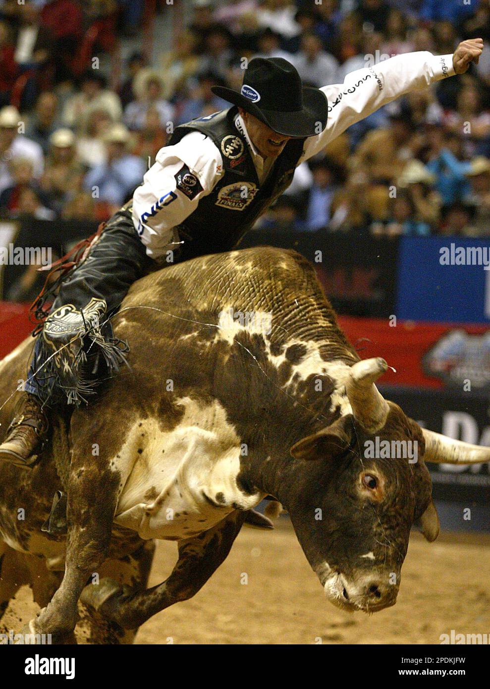 Justin McBride, of Elk City, Okla., hangs on a bull as he Justin McBride, of Elk City, Okla., hangs on a bull as he