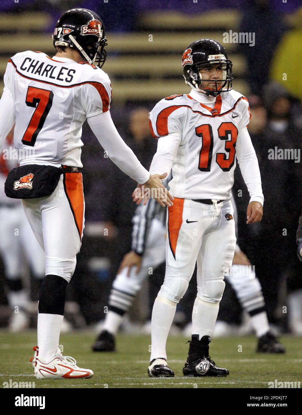 Oregon State kicker Alexis Serna, right, is congratulated by holder