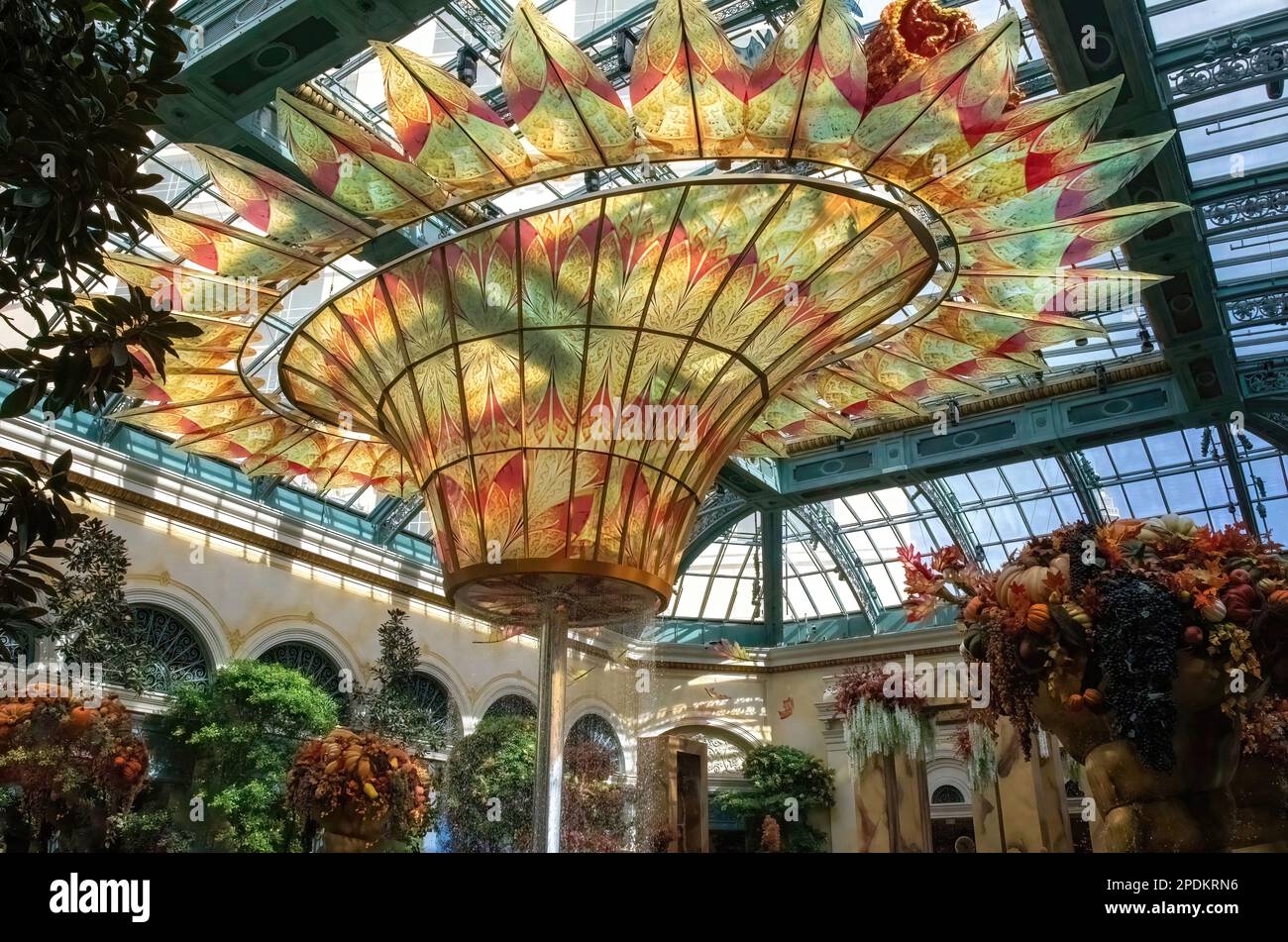 Skylit atrium featuring a closeup of the beautiful fall colored glass fountain and decorations at the Conservatory in the Bellagio Hotel and Casino. Stock Photo